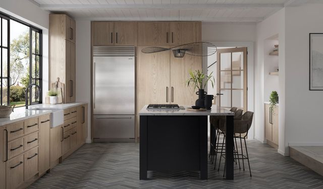 Front view of a modern kitchen with a Sub-Zero bottom freezer refrigerator
